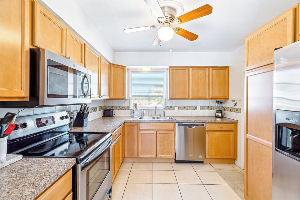 Cozy kitchen with warm wood cabinets and modern appliances for easy meals.