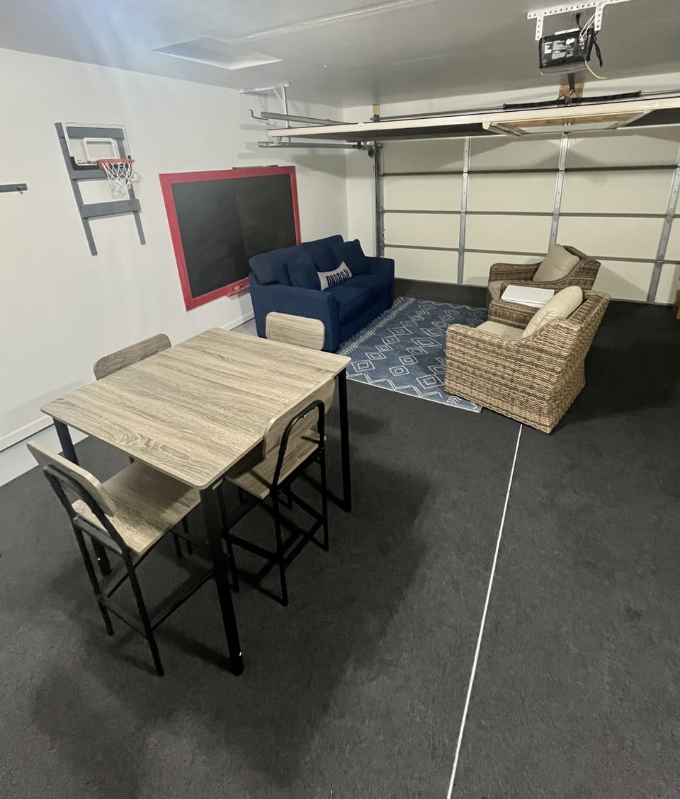 Garage space with table, chairs and seating area. Heater available for cold days