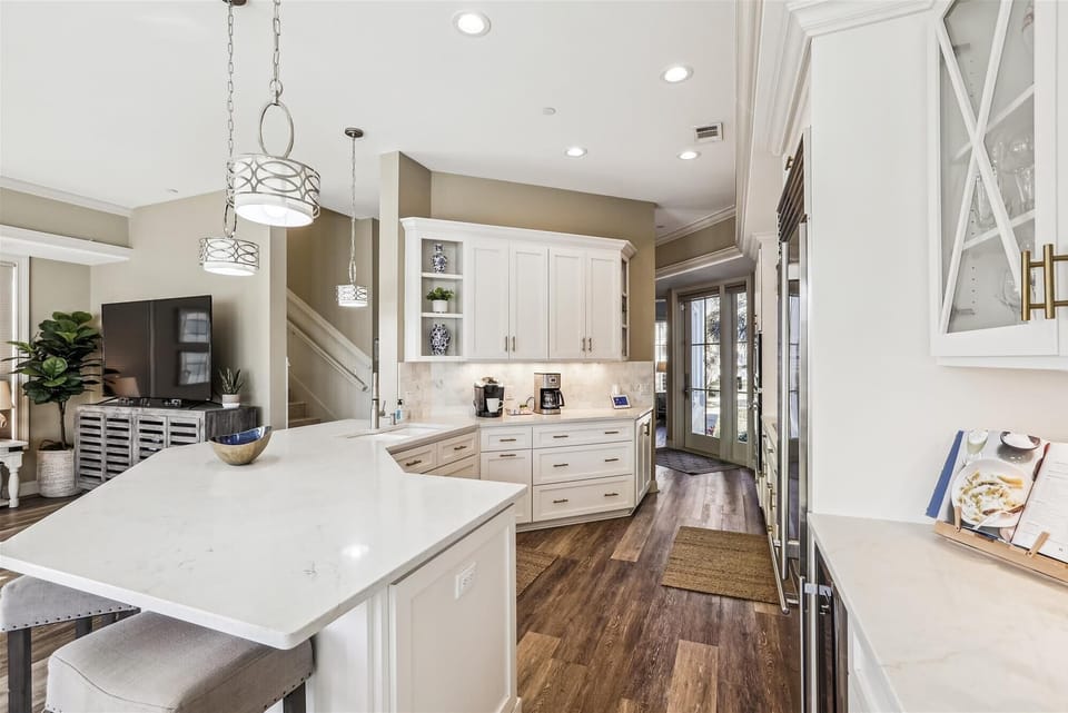 Gourmet kitchen with a gas range, Ninja air fryer, crock pot, and wine fridge.