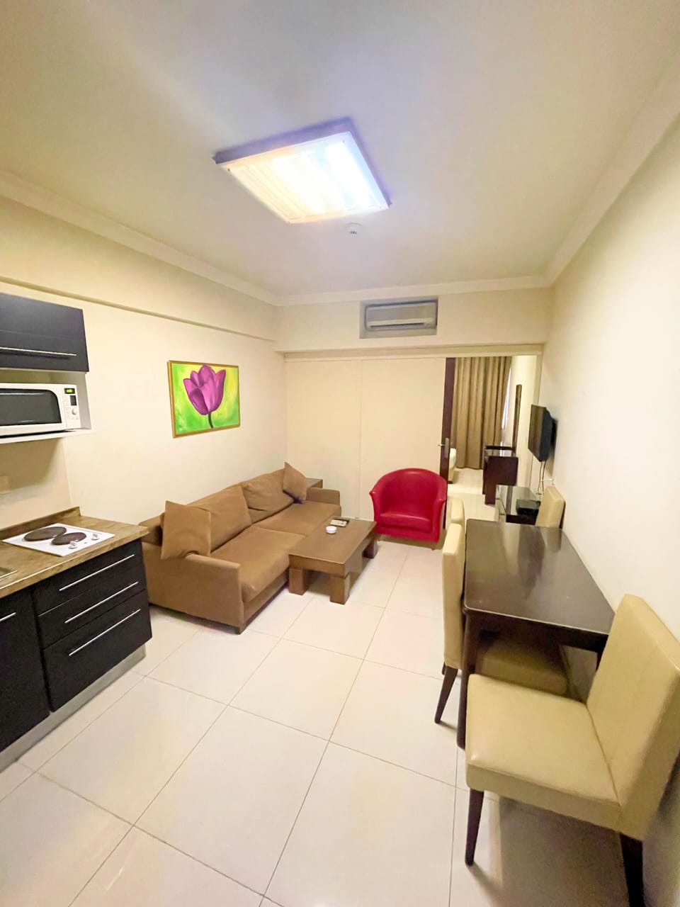 Deluxe Studio Suite | Living area | 40-inch LCD TV with satellite channels