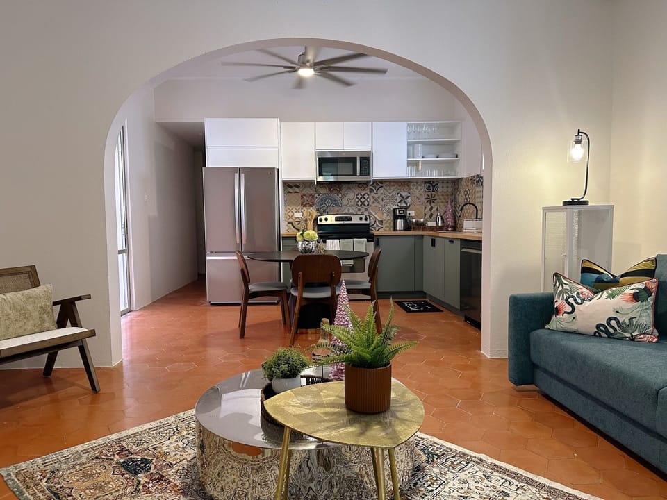 Signature Apartment | Living area | 55-inch Smart TV with digital channels, iPod dock