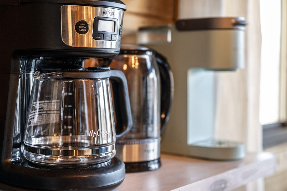 The coffee bar is fully stocked with coffee, tea, and your choice of flavored syrups.