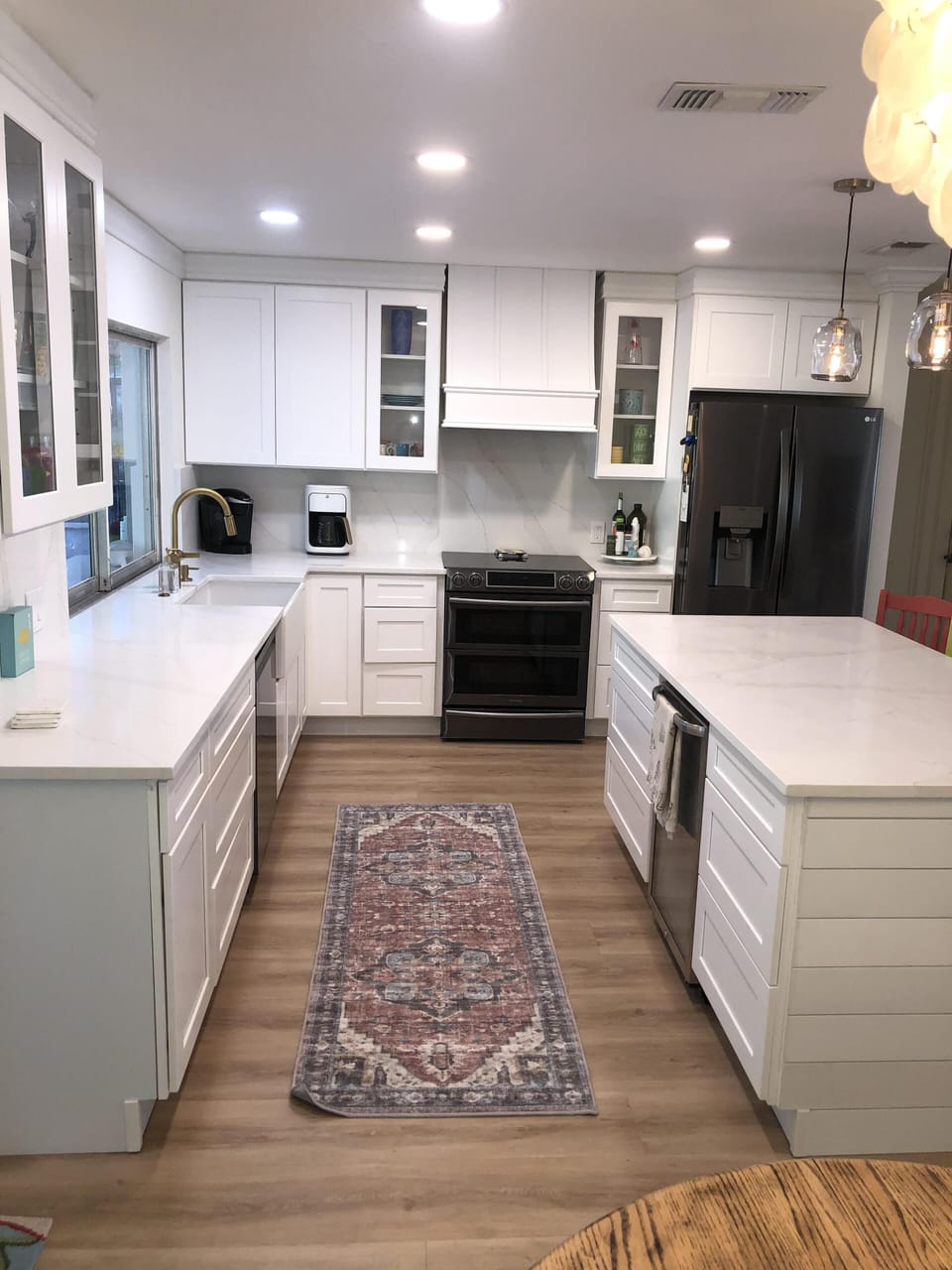 Newly remodeled kitchen features a beverage fridge in the island.