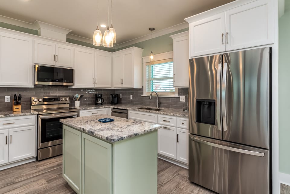 Modern kitchen with stainless steel appliances and granite countertops, perfect for cooking and dining.