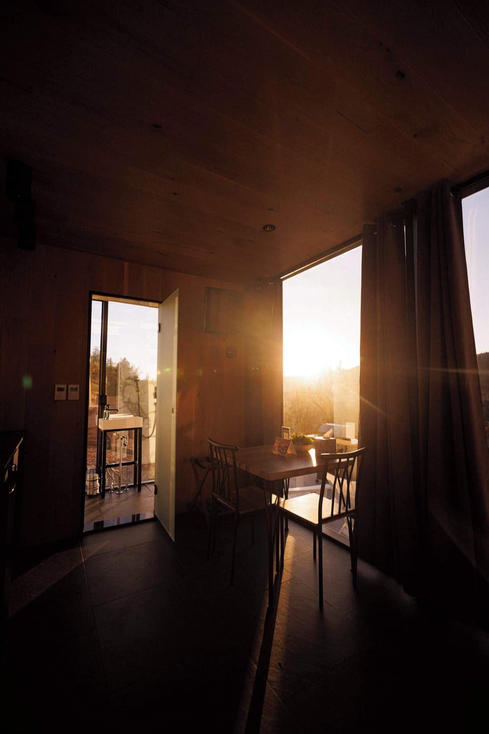 Golden-hour views from inside the Mirror House, where the canyon scenery reflects beautifully through the glass walls.