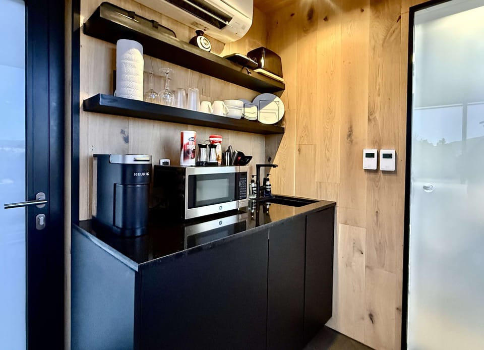 Your mirror accommodation includes a convenient kitchenette with a refrigerator, microwave, Keurig coffee maker, hot plate, toaster, kitchenware, and essentials for simple meals during your stay.