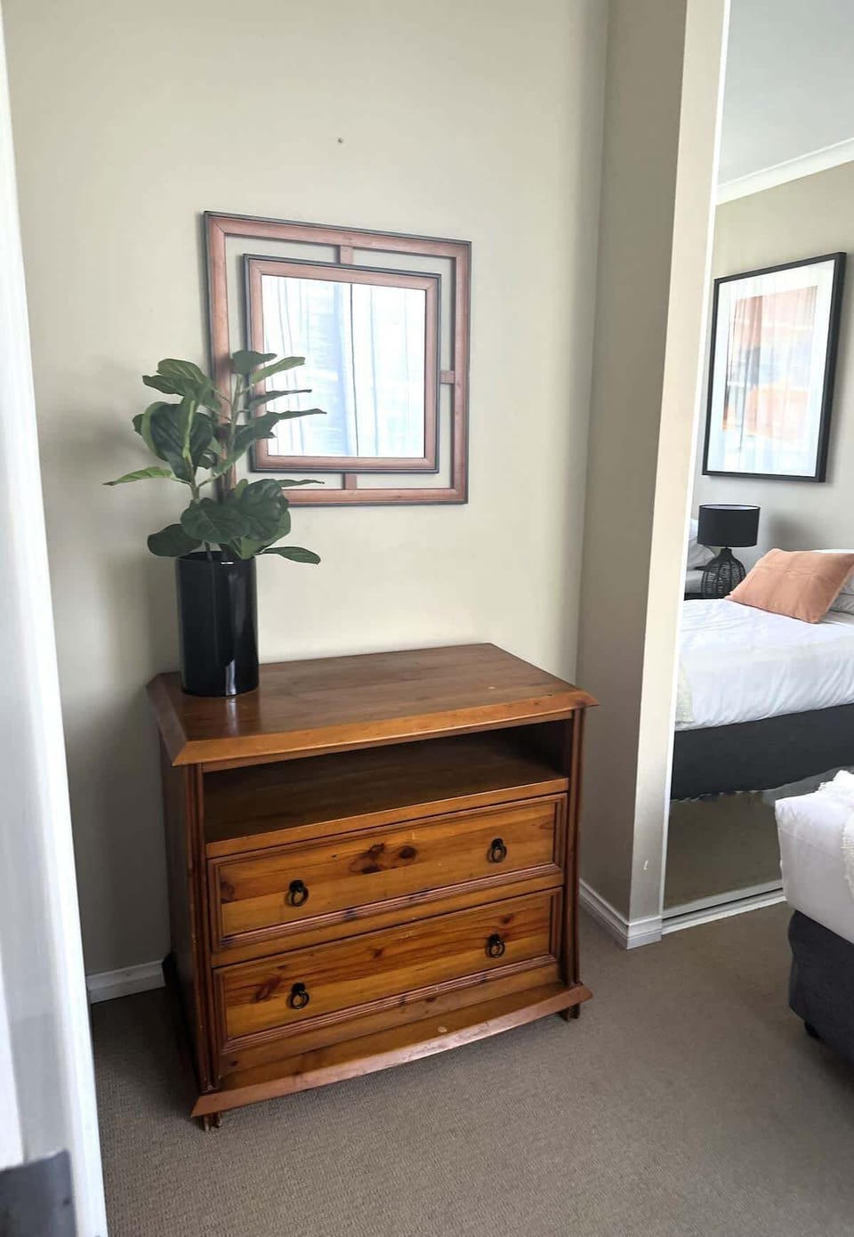 Keep your belongings organized in style! This charming wooden dresser provides ample storage, complemented by modern wall art and a full-length mirror for a convenient stay. 🪵✨