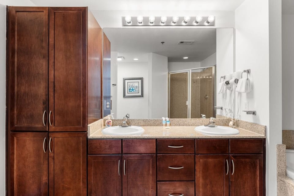 Spacious master bathroom featuring a soaking tub, a separate glass-enclosed shower, and granite accents for a relaxing retreat.