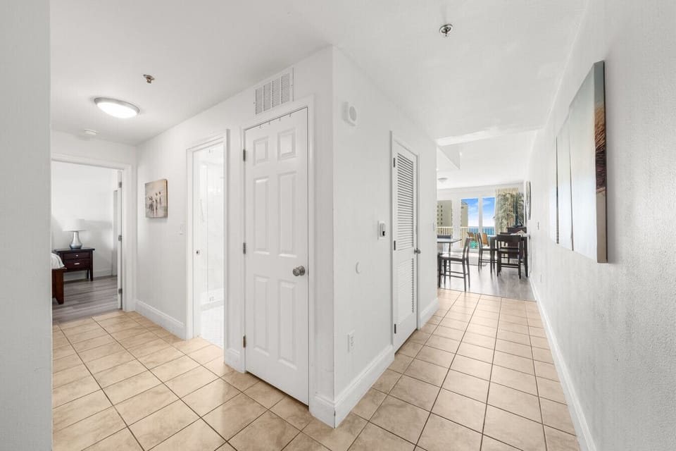 Spacious condo with a bright hallway leading to an open living area and stunning ocean views, perfect for a relaxing getaway