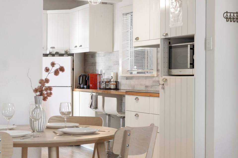 A charming and functional kitchen and dining space, perfect for creating culinary delights or enjoying a meal. 