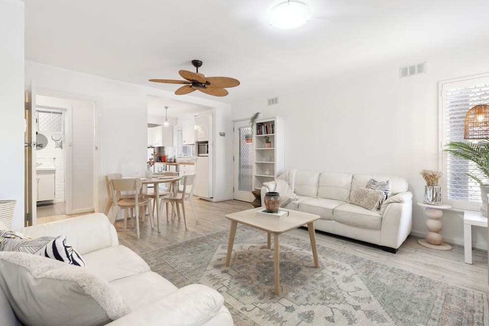 Clean, airy, and cozy—this living space is the perfect retreat.