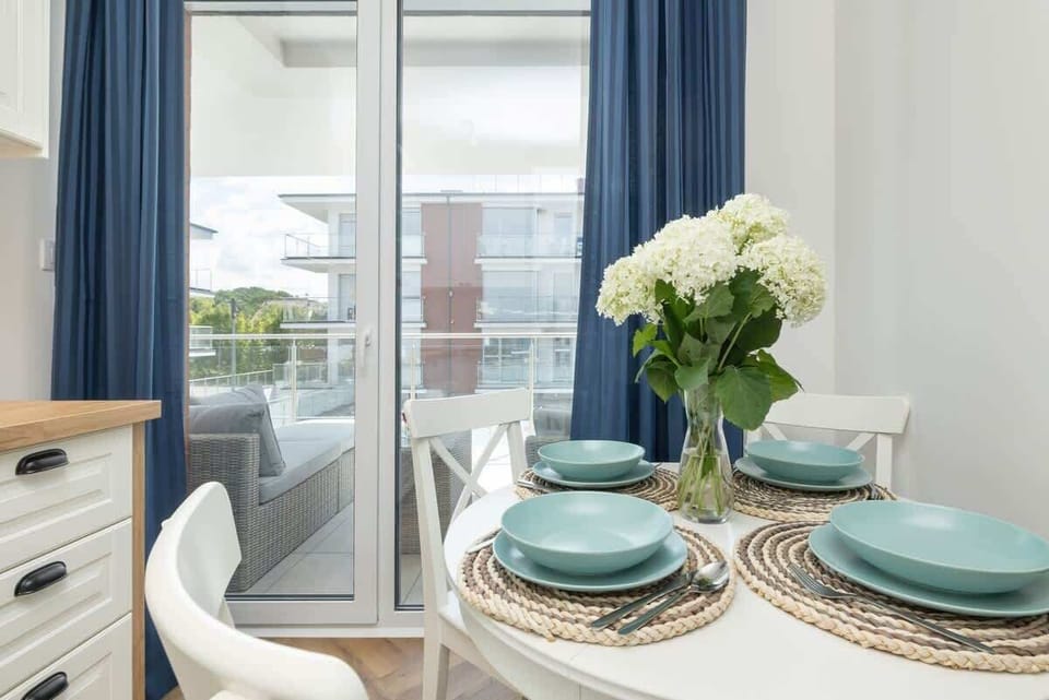 A dining table set for a cozy meal, with blue plates, fresh flowers, and elegant decor.


