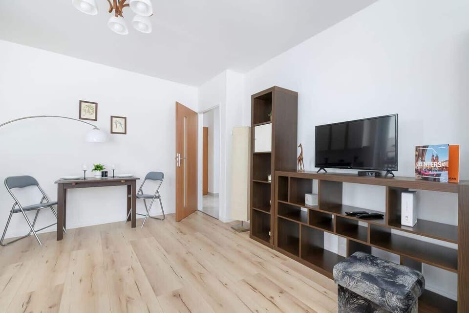 A functional workspace with a wooden desk, chair, and minimalist decor, maintaining a productive and stylish home office.
