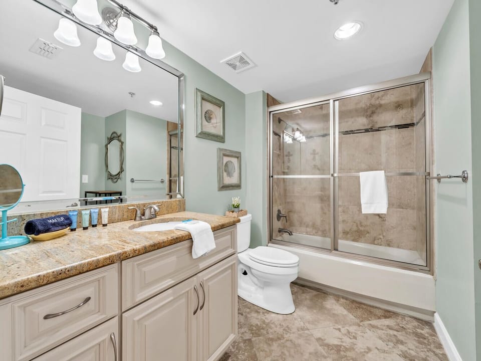 Step into your elegant bathroom with granite counters, modern shower, and soothing mint walls that create a spa-like retreat.