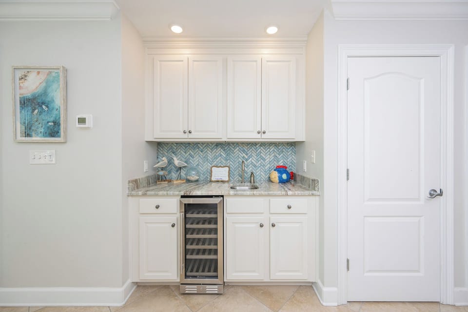 Grab a chilled bottle from the wine cooler or create your favorite cocktail at this elegant wet bar