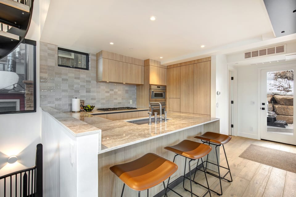Easy access off open living area to the back deck with seating and hot tub