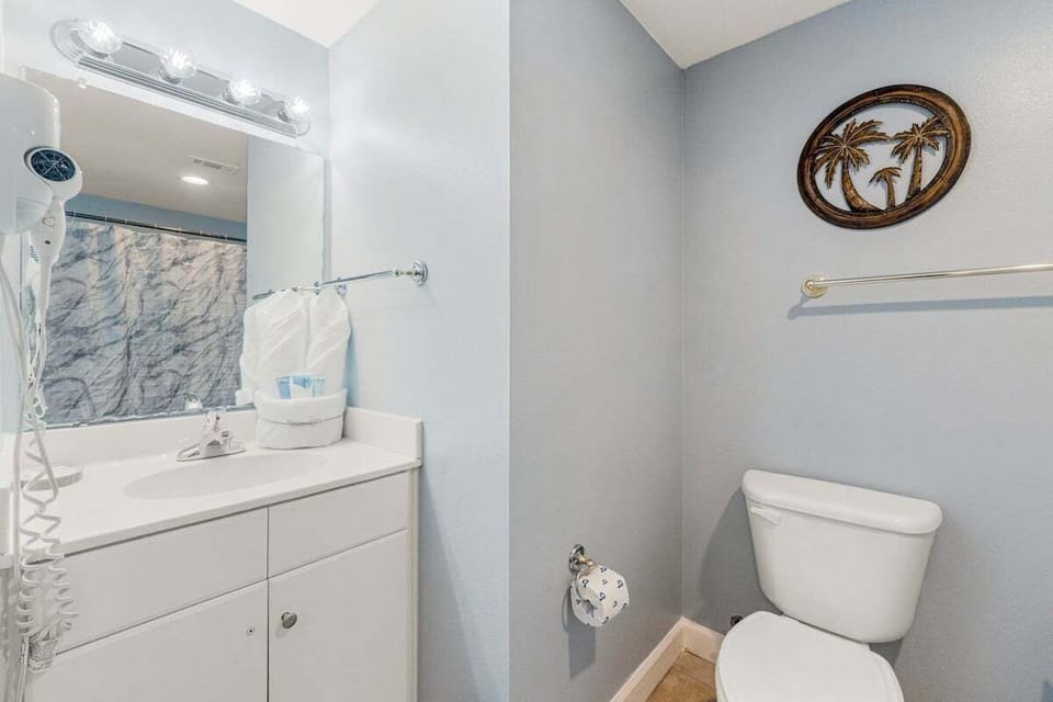 A spacious vanity provides room for getting ready and storing personal essentials.