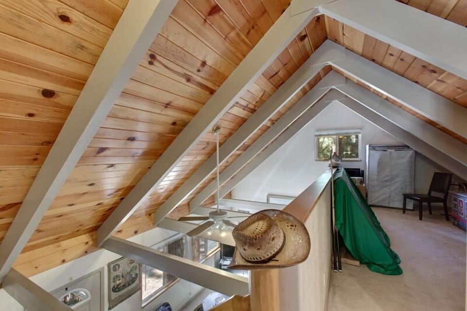 Lofted upper level with an A-frame ceiling, perfect for extra relaxation or a quiet retreat.