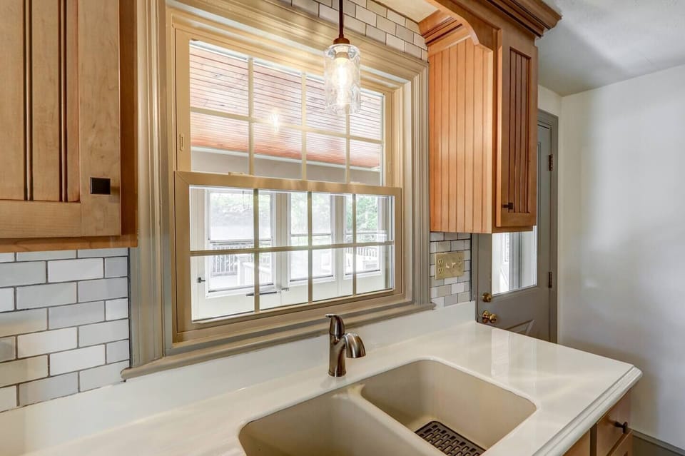 Kitchen with a view of the sun porch leading out to the back patio