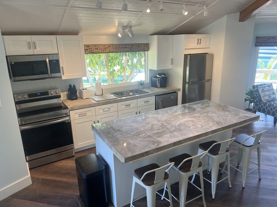 Kitchen with View of Water and Large Island
