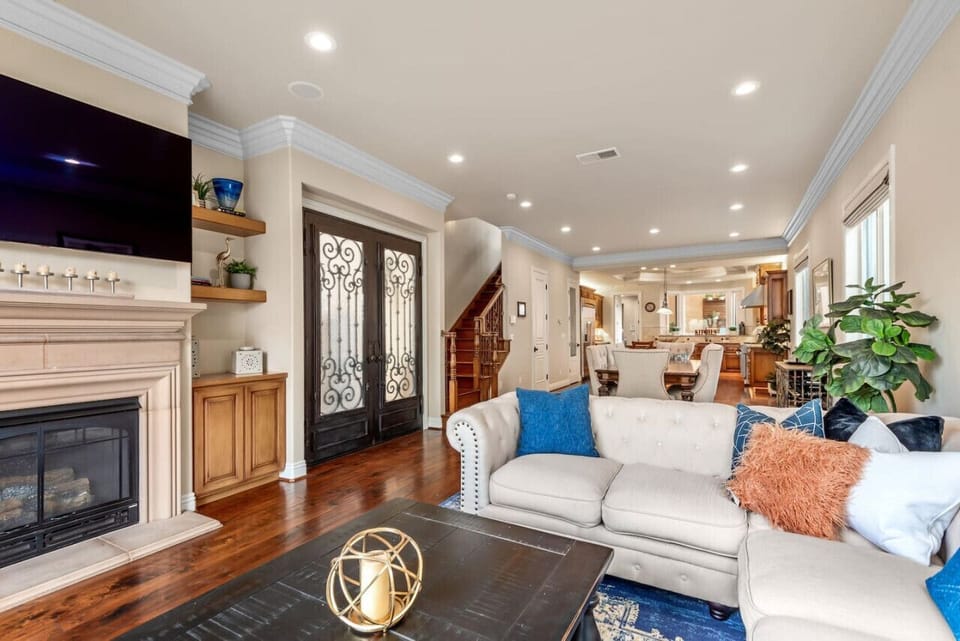 View from living room with lots of seating and smart TV.