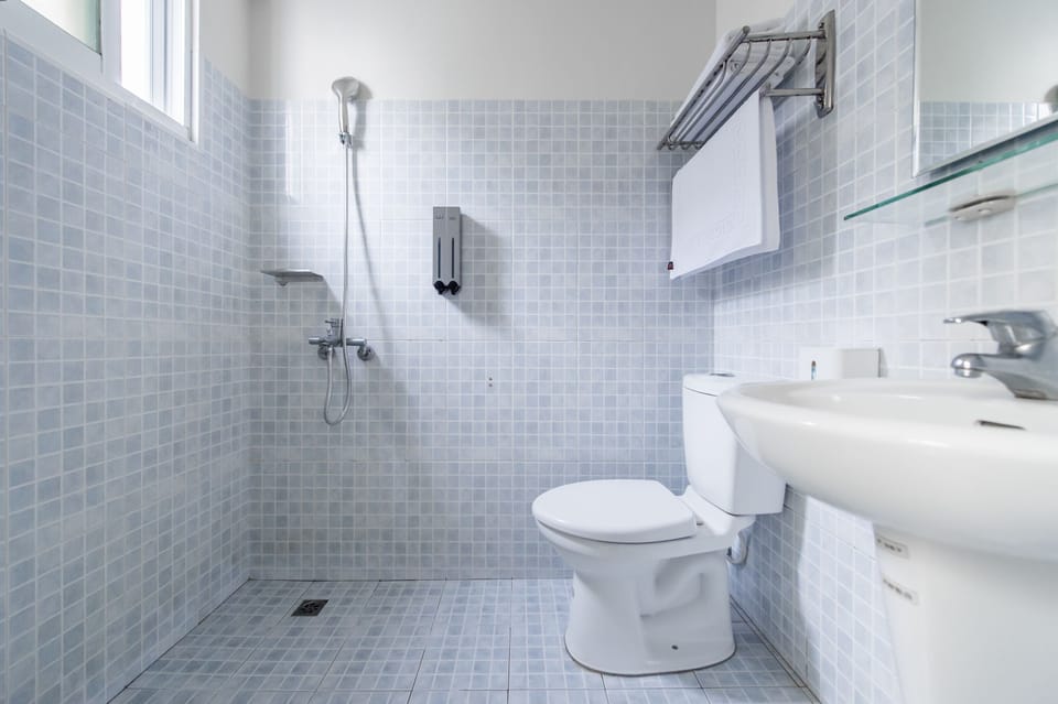 Shower, hair dryer, slippers, towels