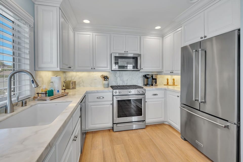 Prepare meals with ease in a sleek, fully-equipped kitchen featuring modern appliances, ample counter space, and a functional layout for cooking and entertaining.