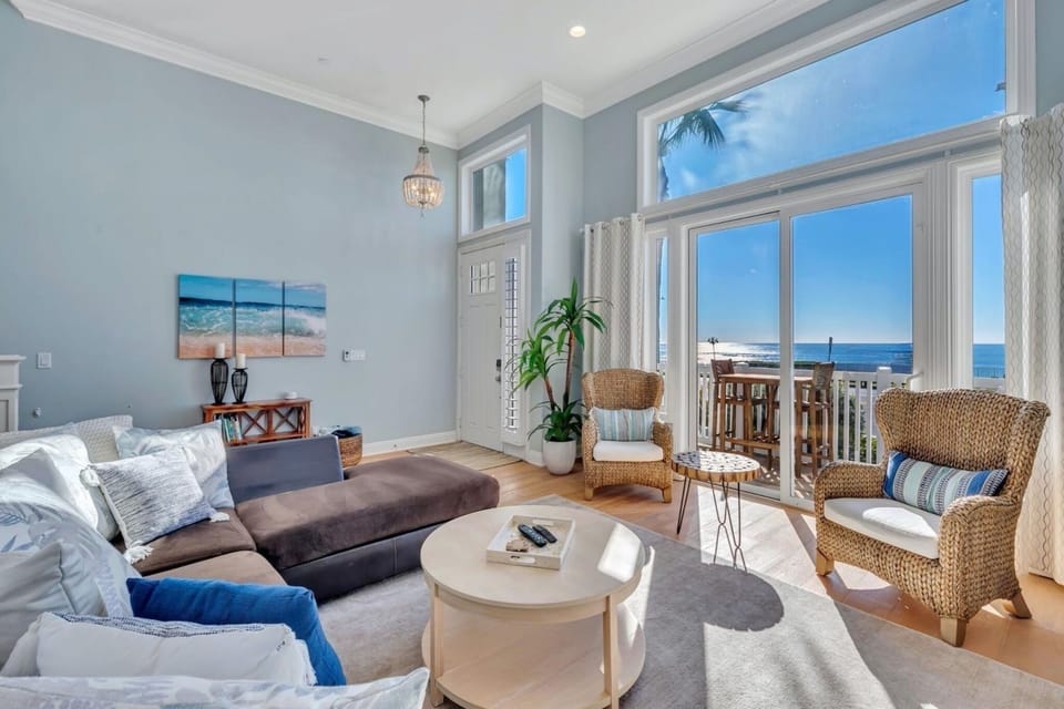 Relax on a large, comfortable sofa while enjoying stunning ocean views, a smart TV with cable, and direct access to the front porch for seamless indoor-outdoor living.
