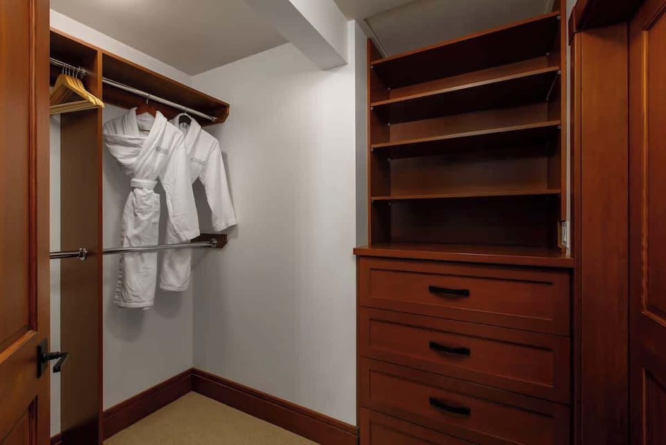 - Spacious walk-in closet with wooden shelving and storage drawers  
- Soft robes and hangers ready for your mountain getaway stay  
- Perfect for organizing ski gear and cozy Whistler essentials  
