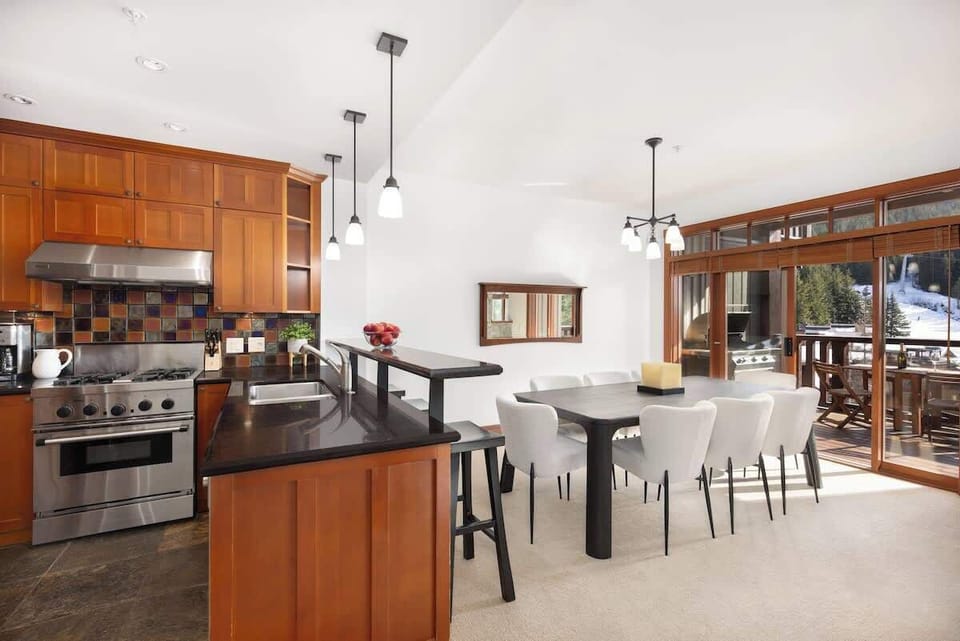 - Open-concept kitchen and dining area filled with natural mountain light  
- Stylish pendant lighting and modern bar seating for casual dining  
- Perfect for gathering after skiing, hiking, or mountain biking  

