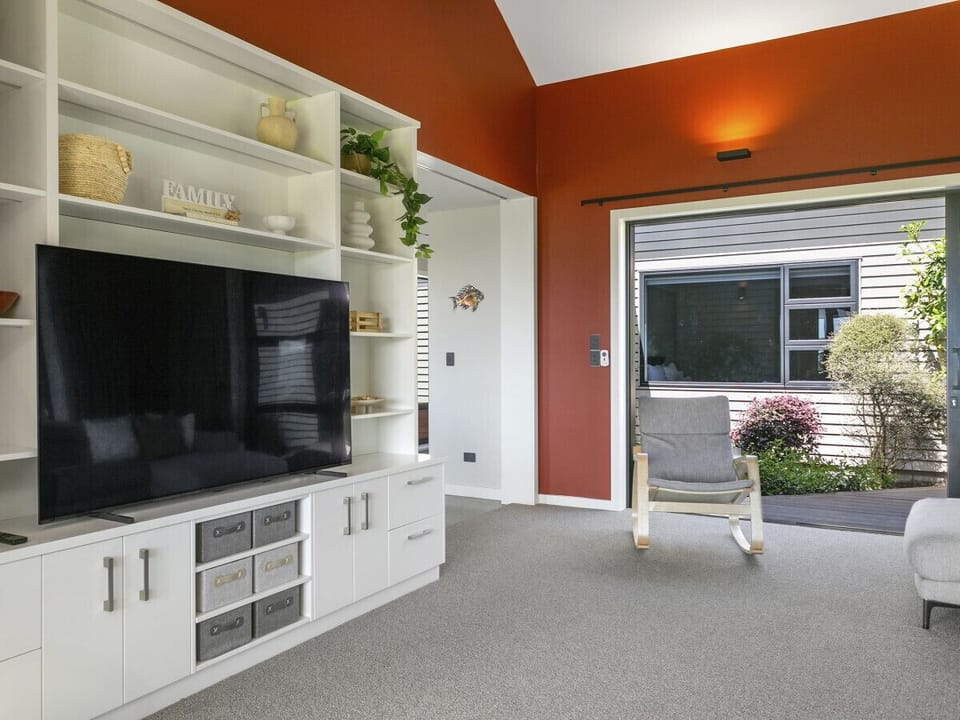 A welcoming lounge seamlessly connects to the outdoor alfresco space.