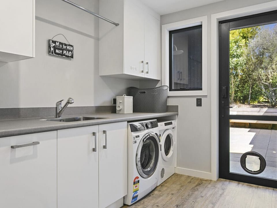Spacious laundry room, fully equipped with washer and dryer amenities.