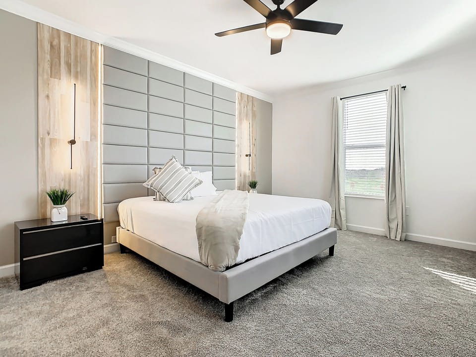 Stylish Bedroom with Padded Headboard and Ambient Lighting