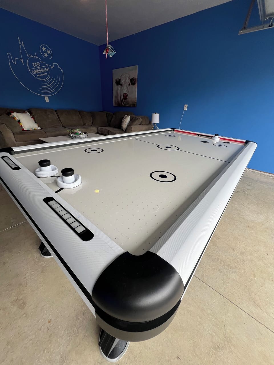 GAME ROOM - Our game room is perfect for some indoor fun, featuring an air hockey table, comfy seating, a large 40" TV, and vibrant decor. A great spot to relax and enjoy with friends or family!