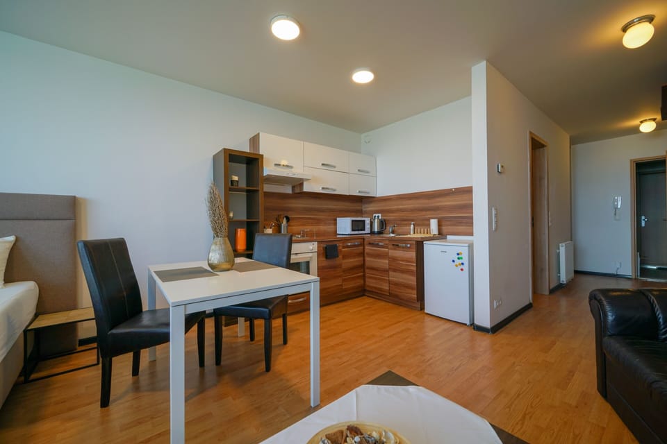 Flora Cozy Apartment by CHORS | Private kitchen | Fridge, microwave, oven, stovetop