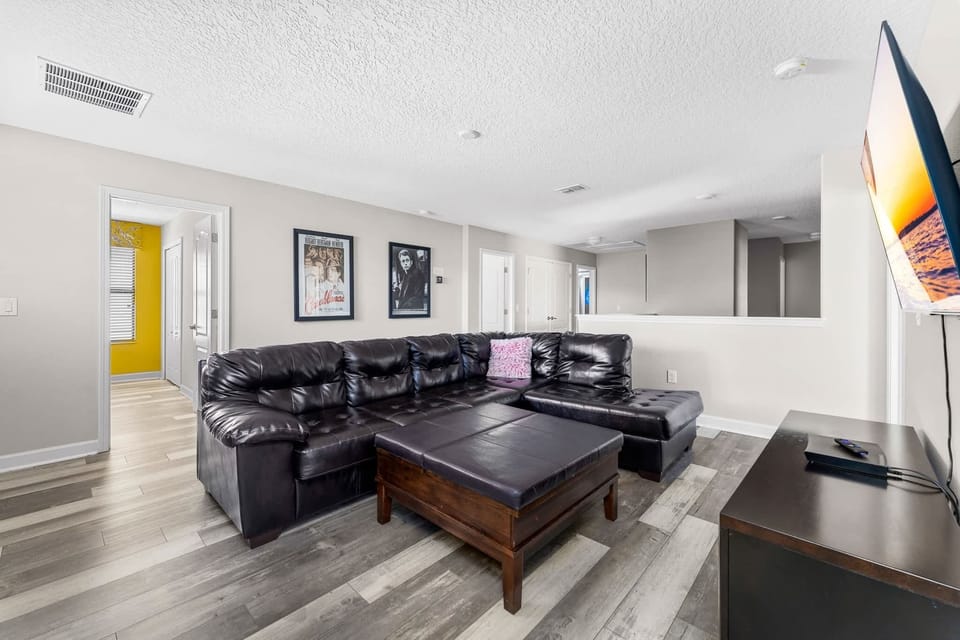 Spacious living room w/ plush sectional seating, perfect for movie nights & relaxing together.