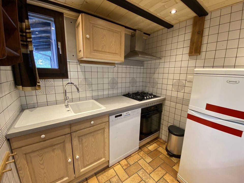 Kitchen with fridge, stove, microwave, coffee maker, kettle, dishwasher