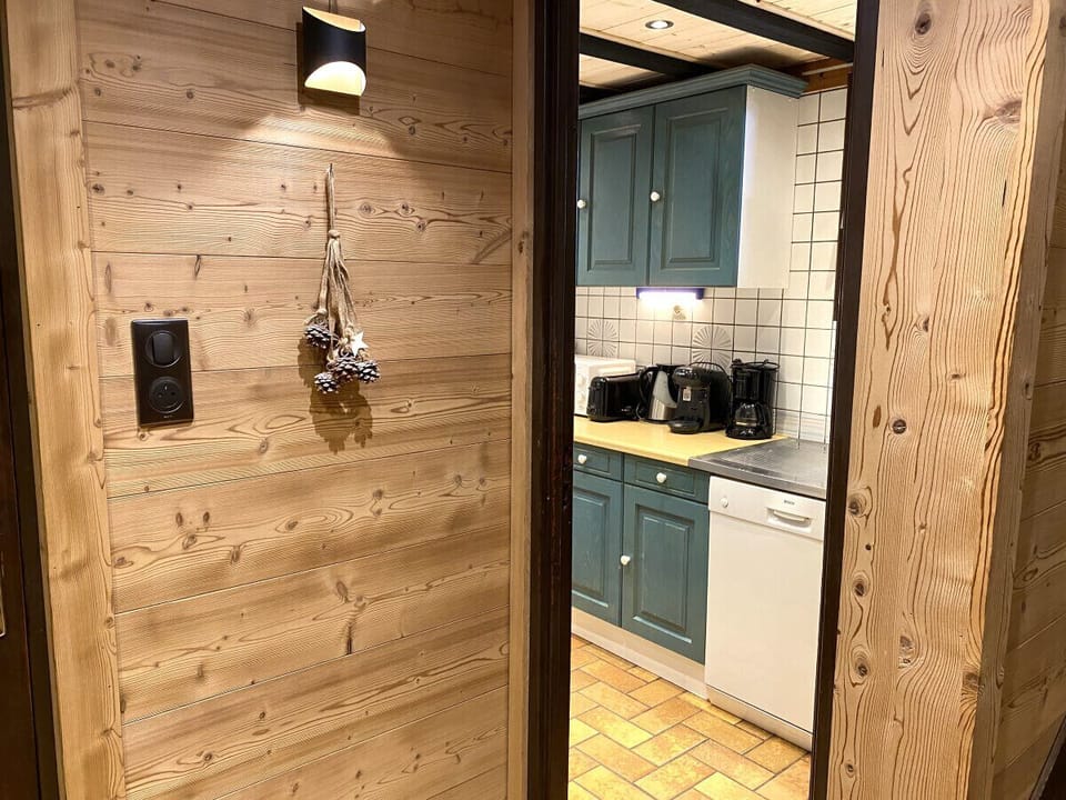 Kitchen with fridge, stove, microwave, coffee maker, kettle, dishwasher