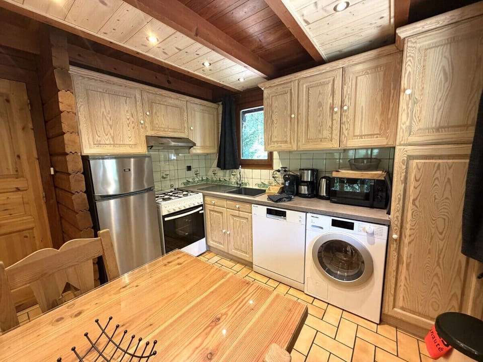 Kitchen with fridge, stove, microwave, coffee maker, kettle, dishwasher, washing machine