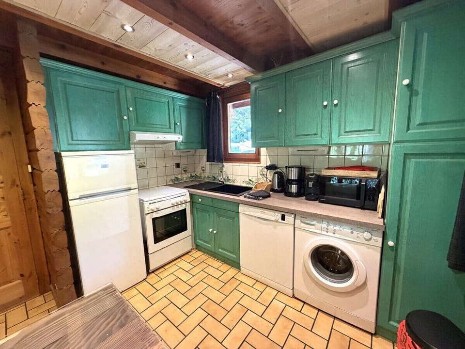 Kitchen with fridge, stove, microwave, coffee maker, kettle, dishwasher, washing machine
