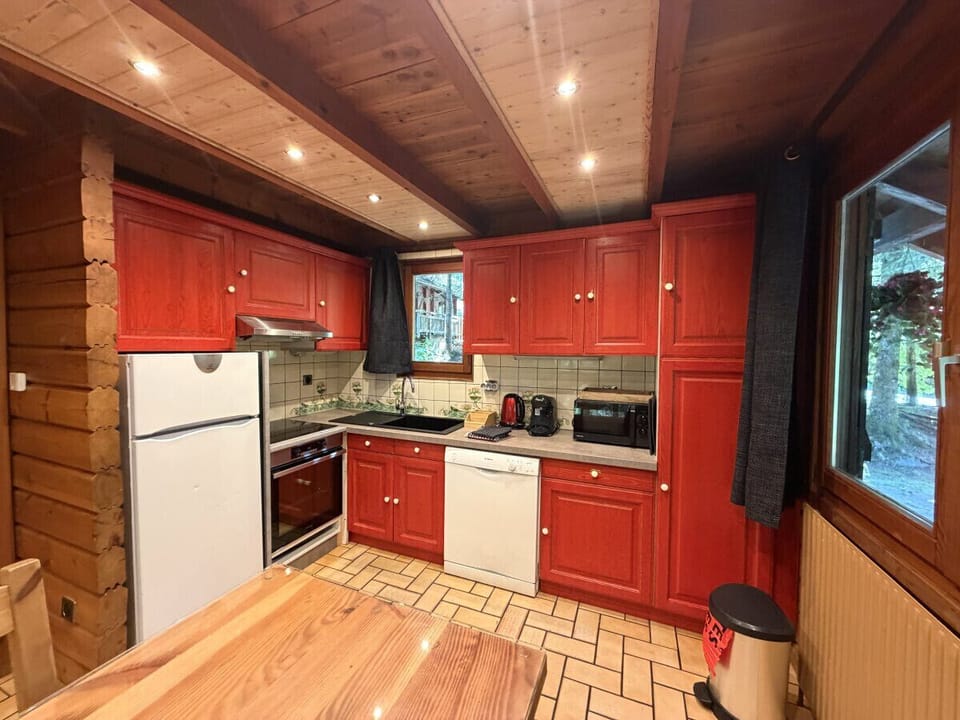 Kitchen with fridge, stove, microwave, coffee maker, kettle, dishwasher, washing machine