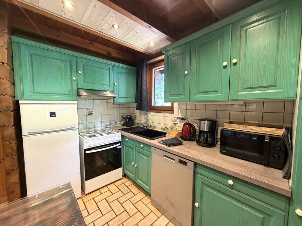 Kitchen with fridge, stove, microwave, coffee maker, kettle, dishwasher, washing machine