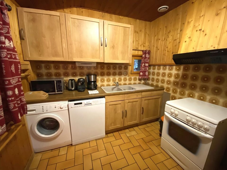 Kitchen with fridge, stove, microwave, coffee maker, kettle, dishwasher, washing machine