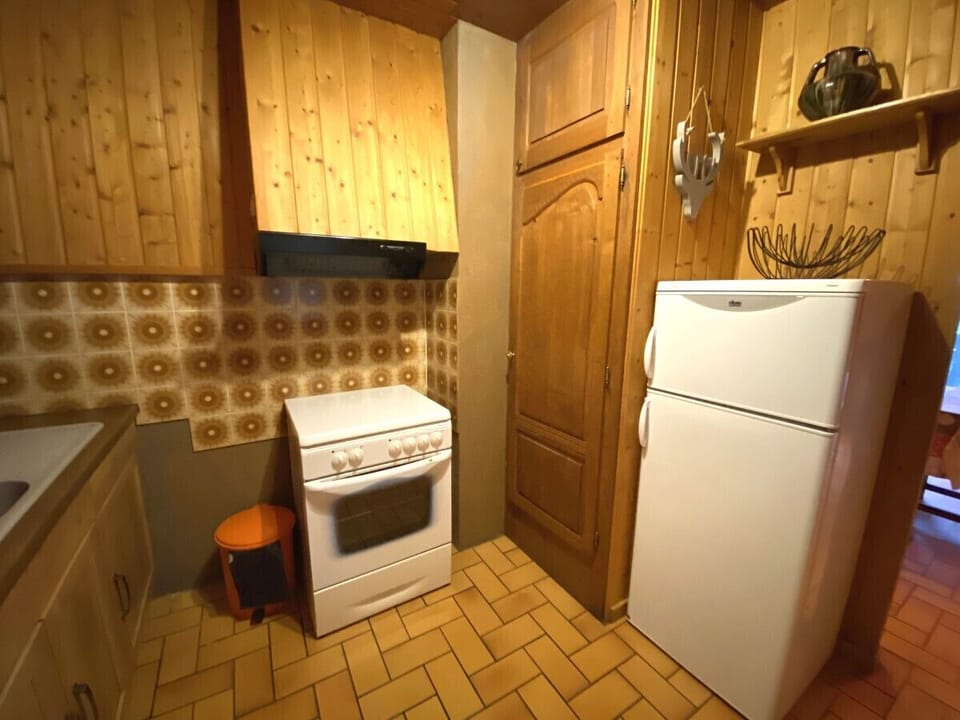 Kitchen with fridge, stove, microwave, coffee maker, kettle, dishwasher, washing machine