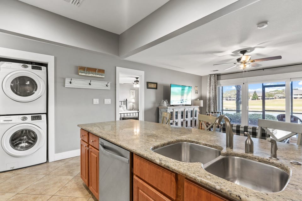 Granite kitchen with open sightlines to the living area and patio—perfect for entertaining and staying connected.