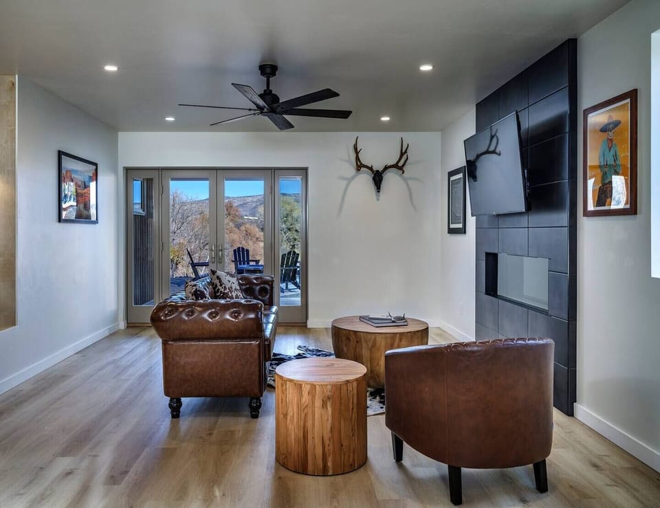 The living room is where you can curl up by the warm fireplace, enveloped in custom Southwest charm. Our living room invites you to unwind with a book or your favorite Netflix show framed by Verde Valley's beauty through the French doors.