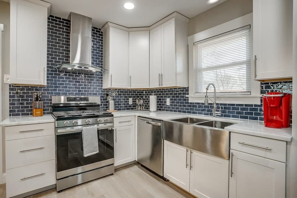 Start your morning by brewing a fresh cup of coffee in this stylish kitchen, where natural light pours in. Prepare a homemade meal with ease, then gather around for laughter and good conversation. A space designed for connection, comfort, and joy!