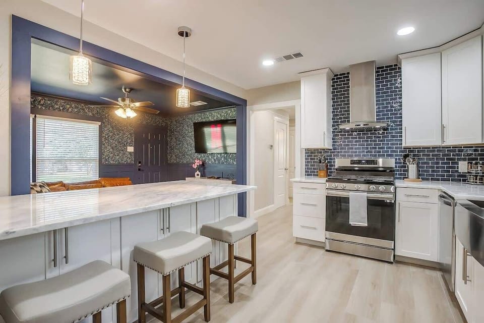 Start your day with coffee at the breakfast bar, catch up on your favorite shows from the cozy nook, or unwind with a glass of wine under warm pendant lights. This open and inviting space is perfect for gathering, sharing meals, and making memories!