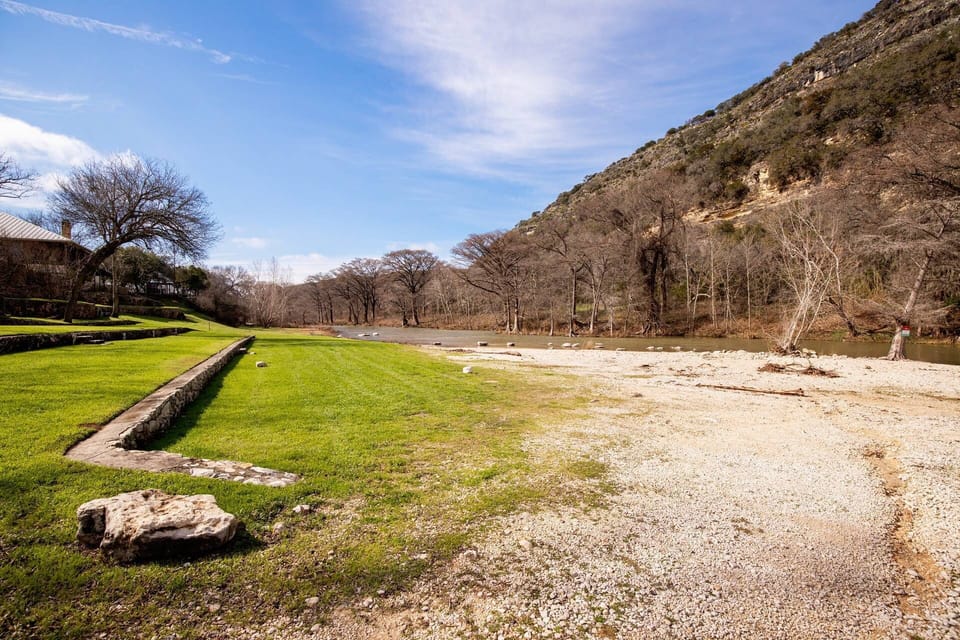 Explore the abundant flat riverbank just steps away, creating an ideal space for leisurely enjoyment against the backdrop of a beautiful cliff view.