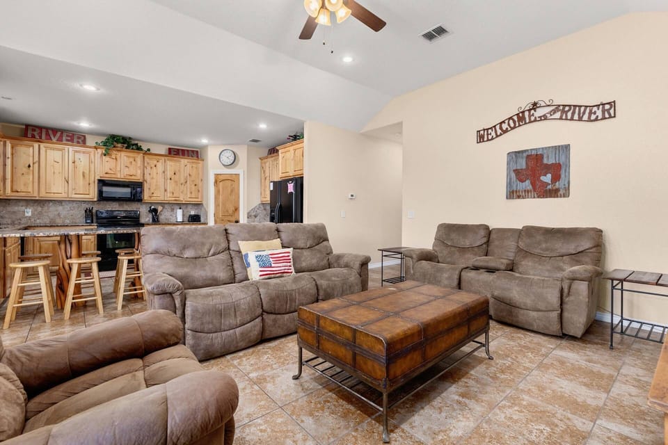 The open living room features plush reclining sofas invite you to unwind in comfort and style – the ideal space for relaxation.